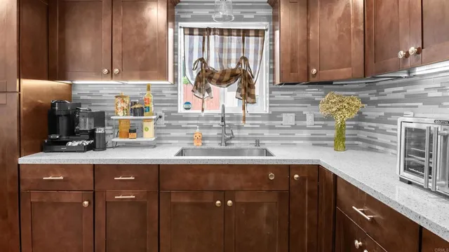 a kitchen with appliances cabinets and a sink