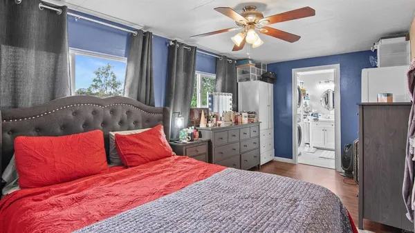 a bedroom with a large bed and a window