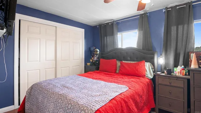 a bedroom with a bed and a bookshelf