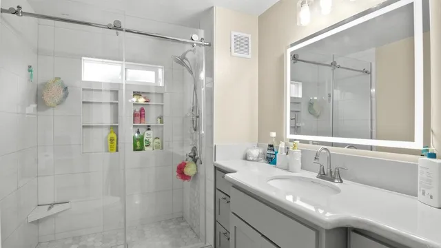a bathroom with a sink vanity mirror and toilet