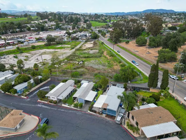 an aerial view of a house with garden space and street view