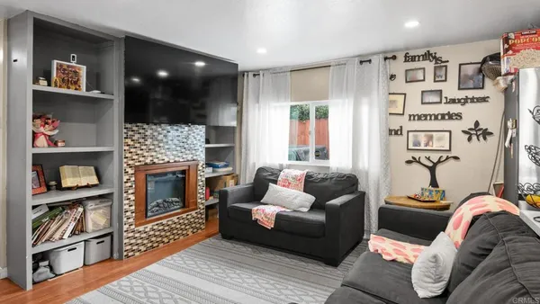 a living room with furniture and a fireplace
