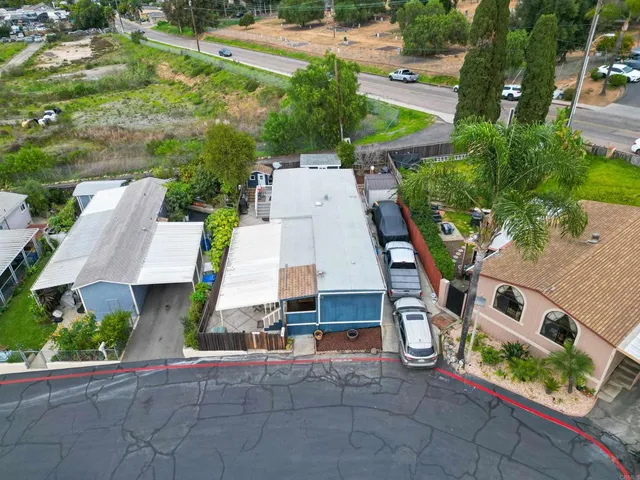 a view of a house with wooden fence