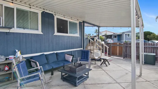 a view of a wooden house with a small yard