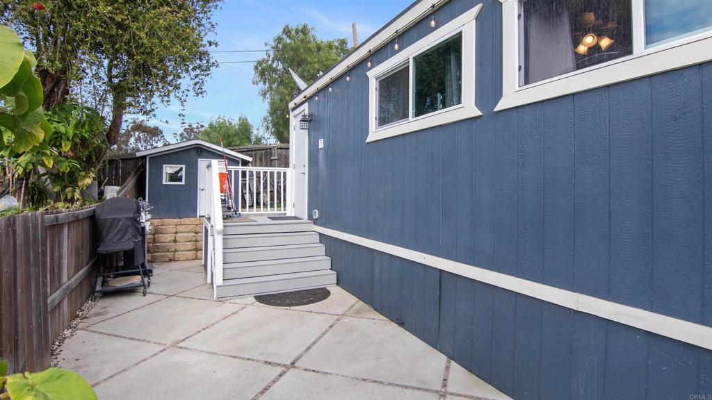 1455 Alturas Street, Unit 46 Fallbrook, CA 92028 - Photo 26 of 34 a view of a wooden house with a small yard