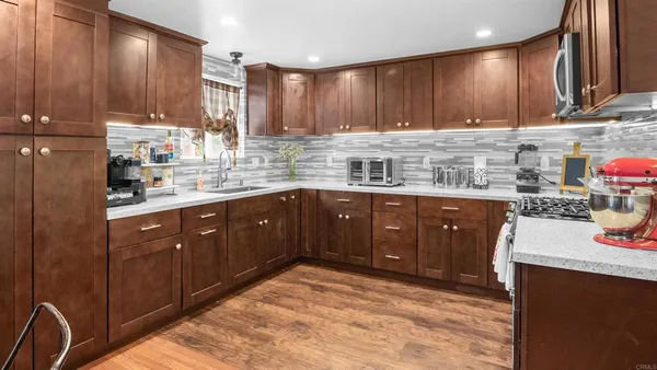 a kitchen with a sink a stove and cabinets