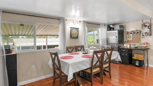 a view of a dining room with furniture window and wooden floor