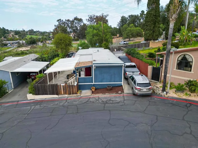 an aerial view of a house with garden space and street view