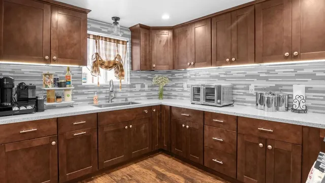 a kitchen with stainless steel appliances granite countertop wooden cabinets a sink and dishwasher
