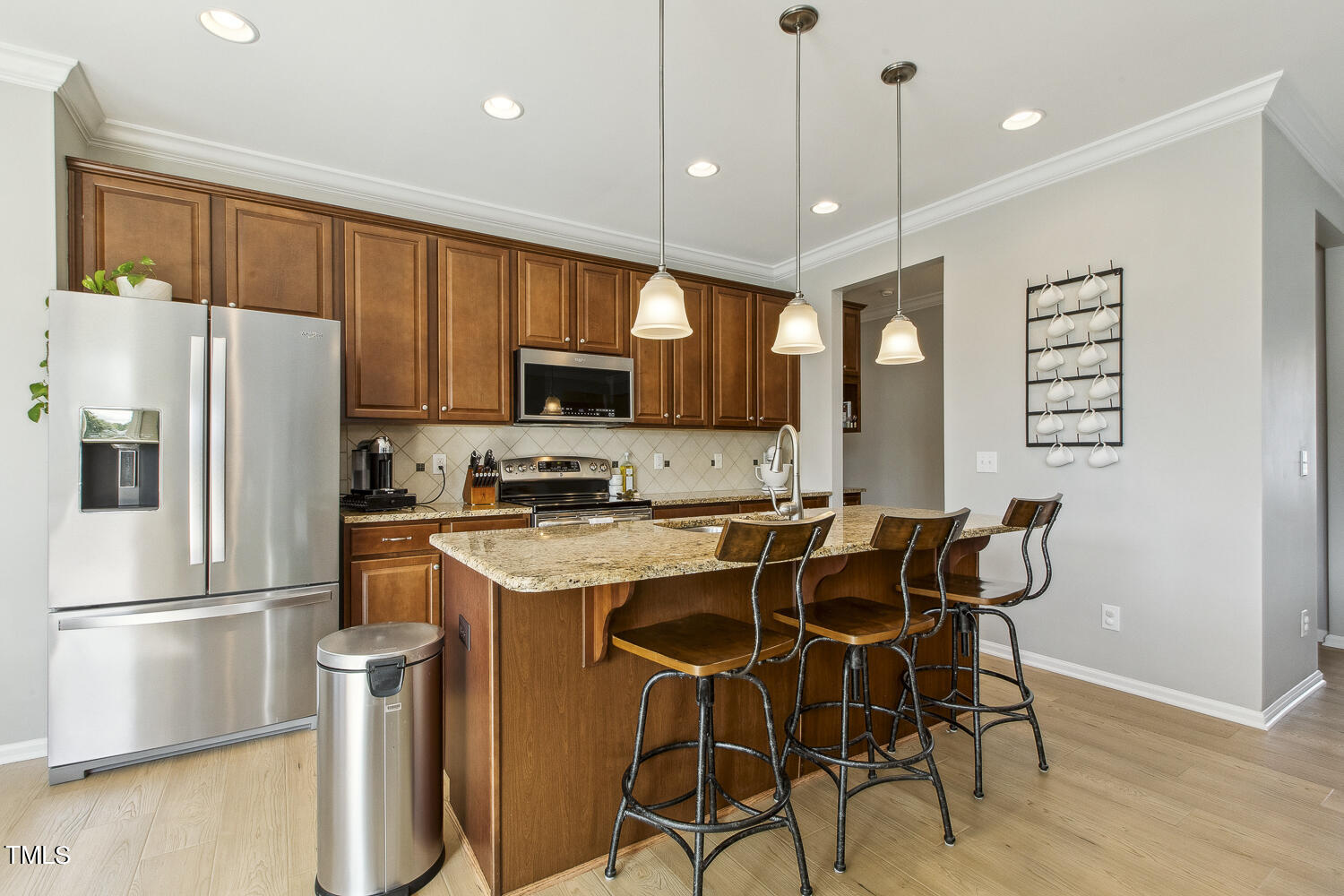 3604 Norman Blalock Road Willow Spring, NC 27592 - Photo 19 of 51 a kitchen with a refrigerator a microwave a stove and a wooden floor