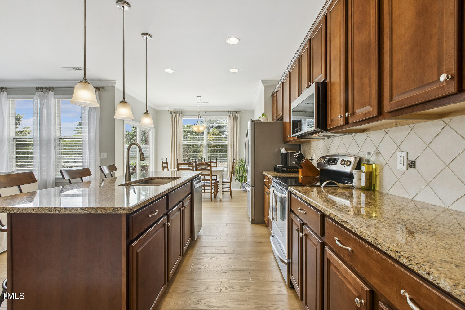 3604 Norman Blalock Road Willow Spring, NC 27592 - Photo 23 of 51 a kitchen with granite countertop a sink stove and cabinets