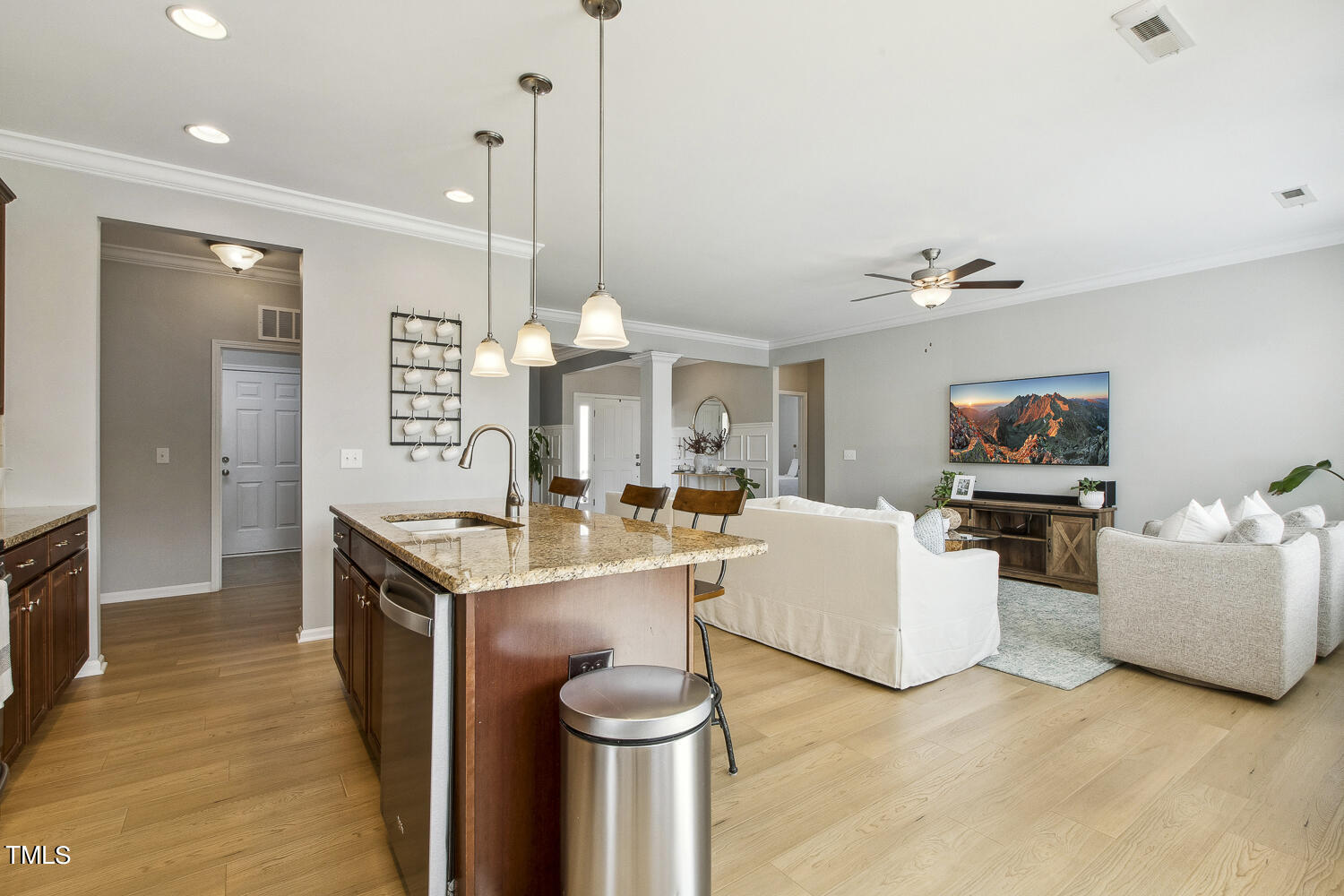 3604 Norman Blalock Road Willow Spring, NC 27592 - Photo 25 of 51 a living room with furniture a flat screen tv and kitchen view