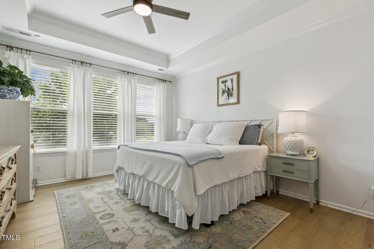 3604 Norman Blalock Road Willow Spring, NC 27592 - Photo 29 of 51 a bedroom with a bed and a chandelier