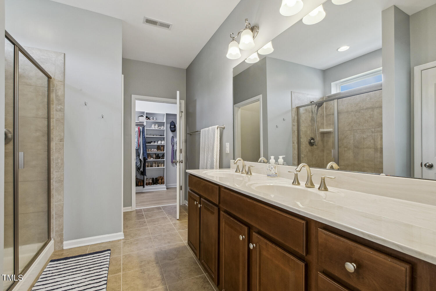 3604 Norman Blalock Road Willow Spring, NC 27592 - Photo 33 of 51 a spacious bathroom with a double vanity sink and a mirror