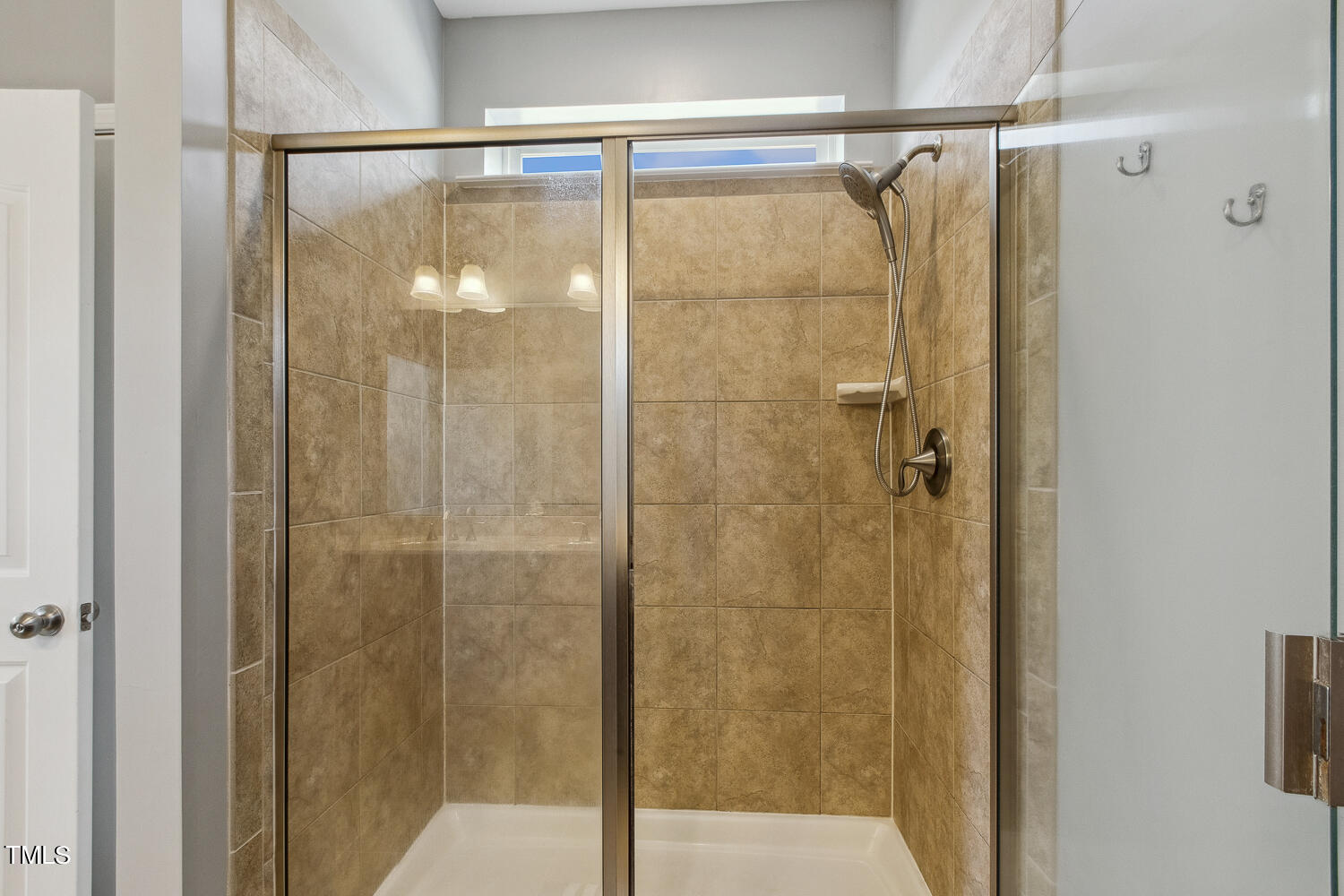 3604 Norman Blalock Road Willow Spring, NC 27592 - Photo 34 of 51 a bathroom with a glass shower door