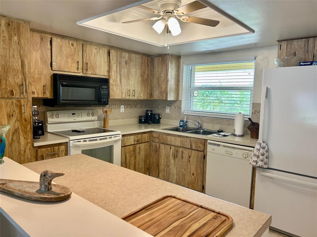 2567 Oakleaf Lane, Unit 41B Clearwater, FL 33763 - Photo 2 of 24 a kitchen with kitchen island granite countertop a sink stainless steel appliances and cabinets
