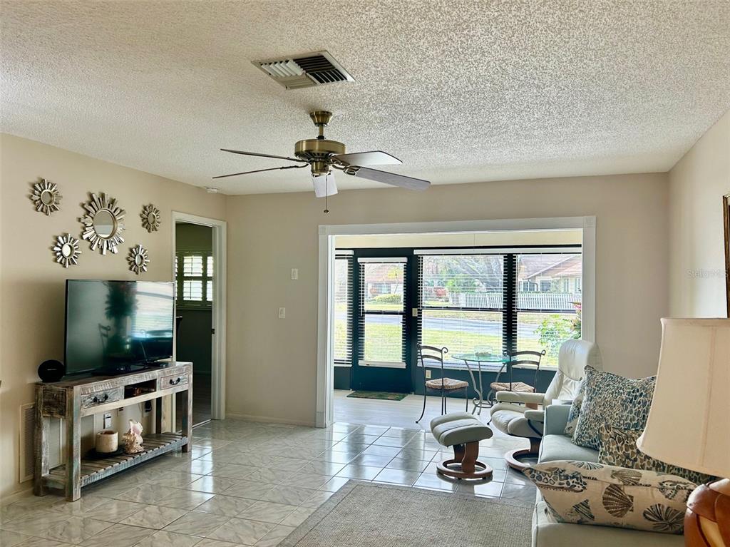 2567 Oakleaf Lane, Unit 41B Clearwater, FL 33763 - Photo 4 of 24 a living room with furniture a window and a flat screen tv