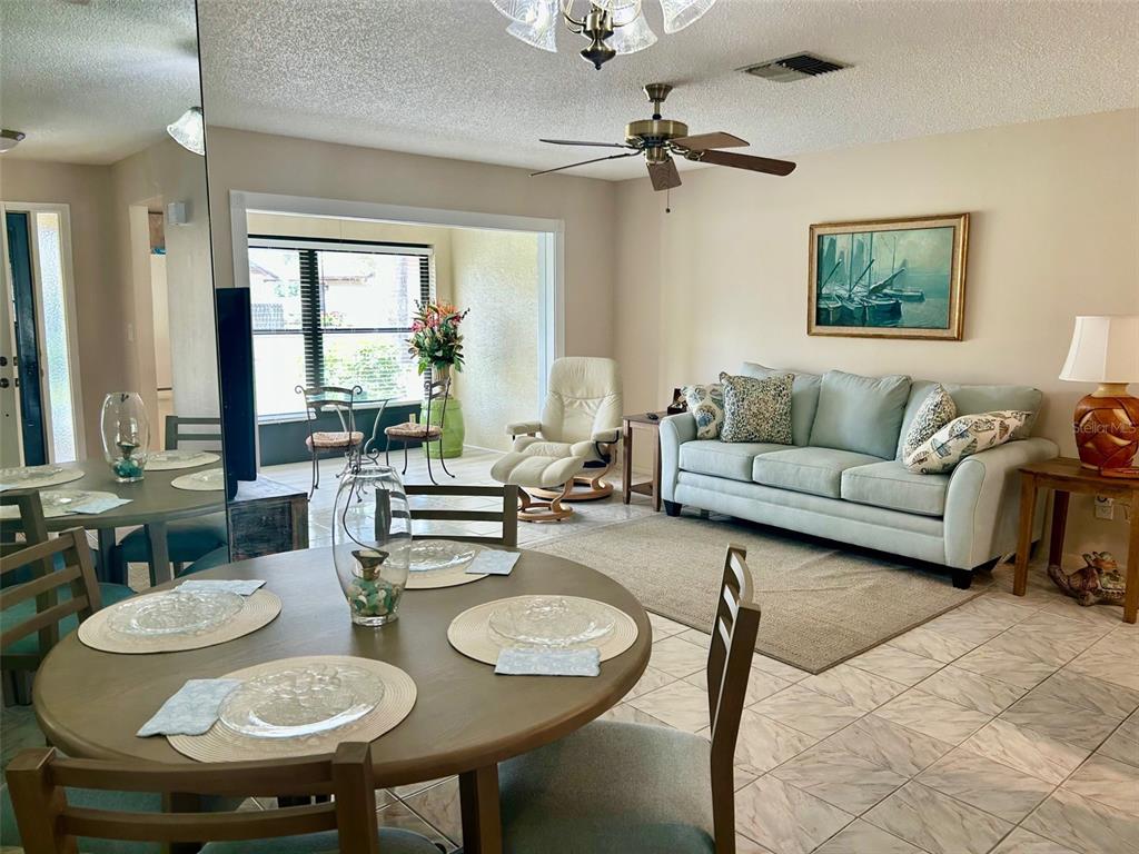 2567 Oakleaf Lane, Unit 41B Clearwater, FL 33763 - Photo 5 of 24 a living room with furniture a large window and a table