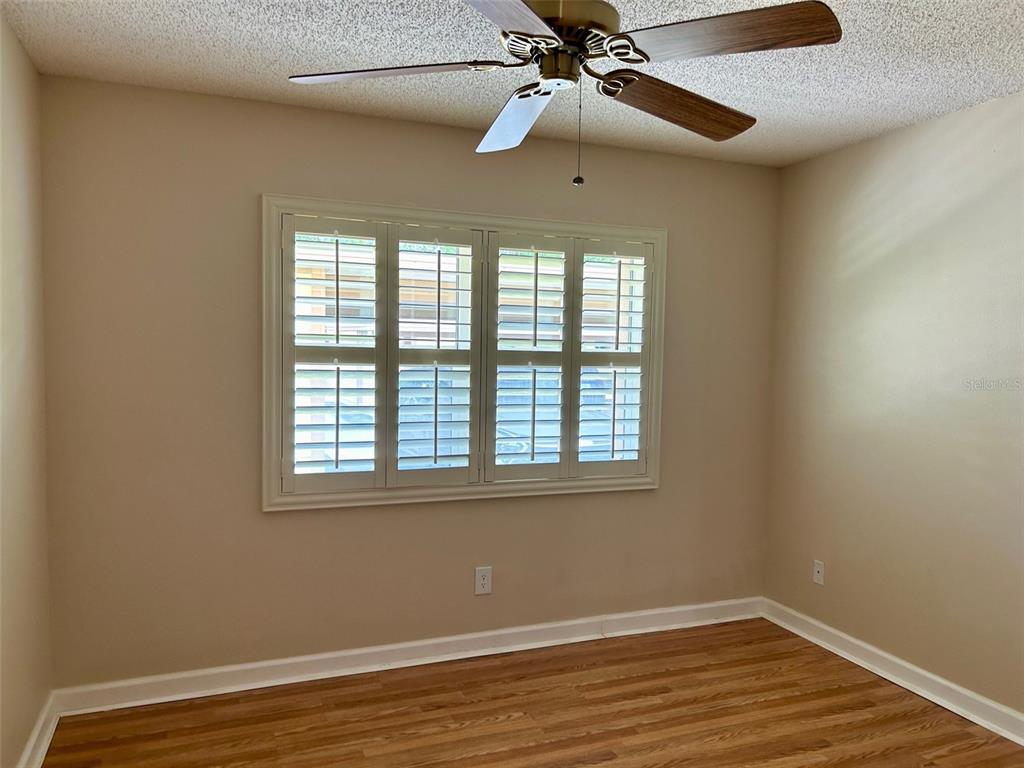 2567 Oakleaf Lane, Unit 41B Clearwater, FL 33763 - Photo 9 of 24 a view of an empty room with wooden floor and a window