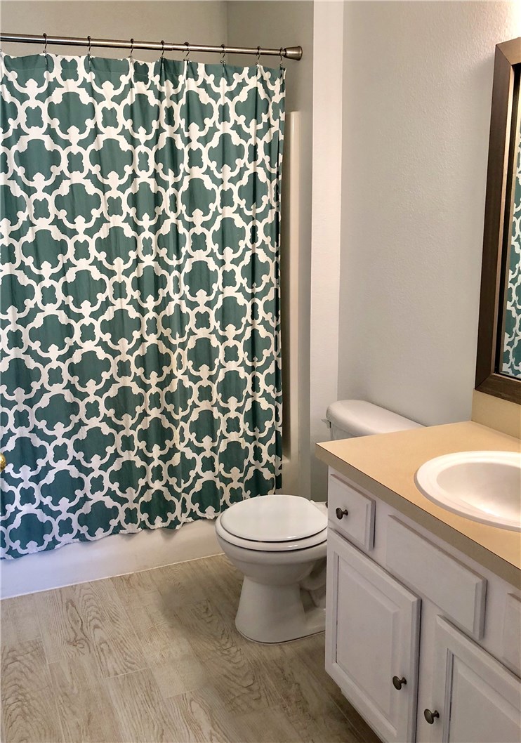 7920 Merrill Road Jacksonville, FL 32277 - Photo 3 of 22 a bathroom with a granite countertop toilet and a sink