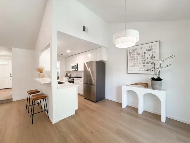 a kitchen with a refrigerator and a sink