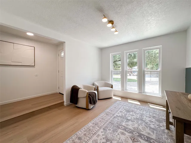 a spacious bedroom with a bed and a large window