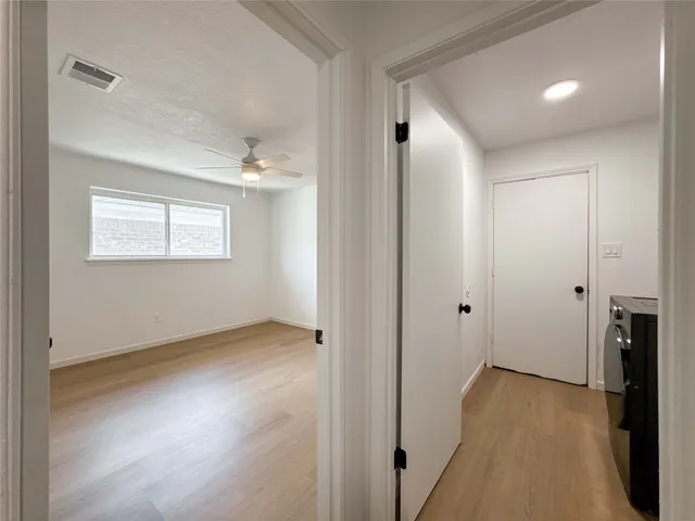 a view of a room with wooden floor and a window