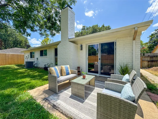 a view of a house with backyard sitting area and garden