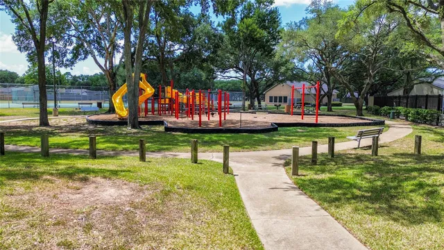 a childrens park with lots of trees and plants