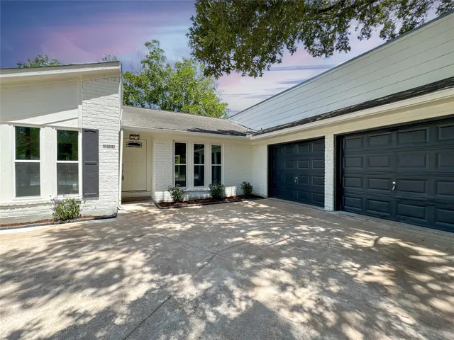 a view of a house with a yard and garage