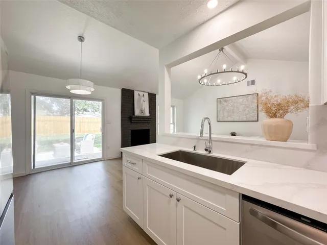 a kitchen with a sink and chandelier