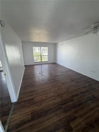 a view of a room with wooden floor
