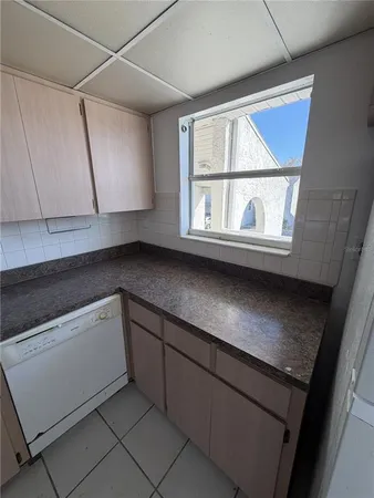 a kitchen with appliances cabinets and a window