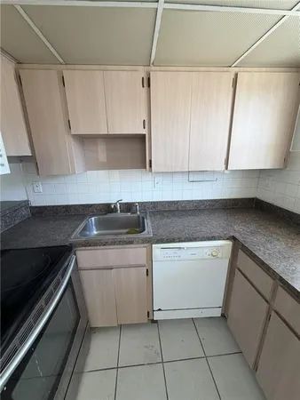 a kitchen with a sink and cabinets