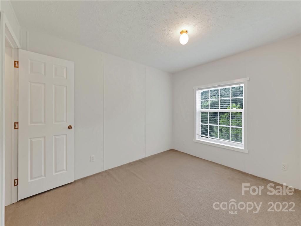 70 Sugar Cove Road Clyde, NC 28721 - Photo 11 of 21 an empty room with a window