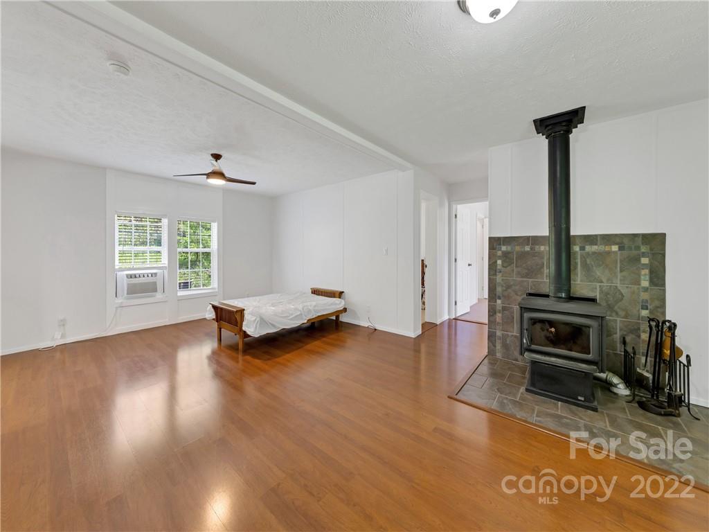 70 Sugar Cove Road Clyde, NC 28721 - Photo 3 of 21 a view of livingroom with furniture and a fireplace