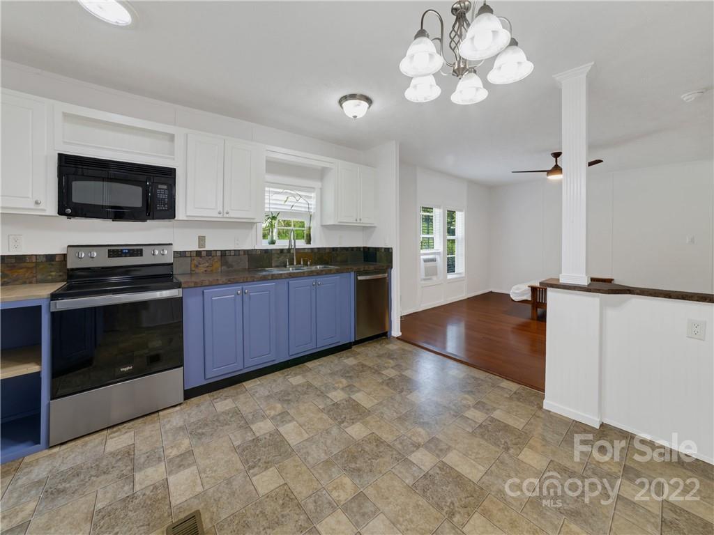 70 Sugar Cove Road Clyde, NC 28721 - Photo 7 of 21 a kitchen with stainless steel appliances granite countertop a stove cabinets and microwave