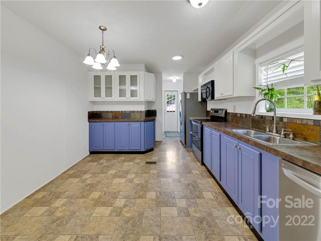 70 Sugar Cove Road Clyde, NC 28721 - Photo 8 of 21 a large kitchen with cabinets a sink and dishwasher