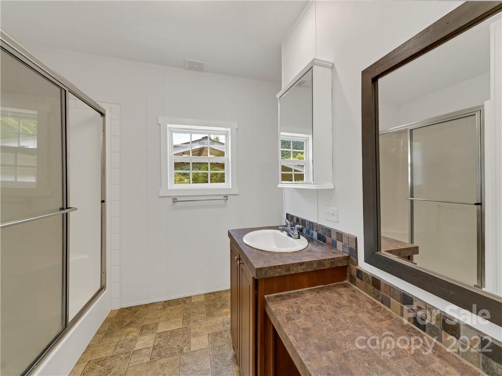 70 Sugar Cove Road Clyde, NC 28721 - Photo 10 of 21 a bathroom with a sink and a mirror
