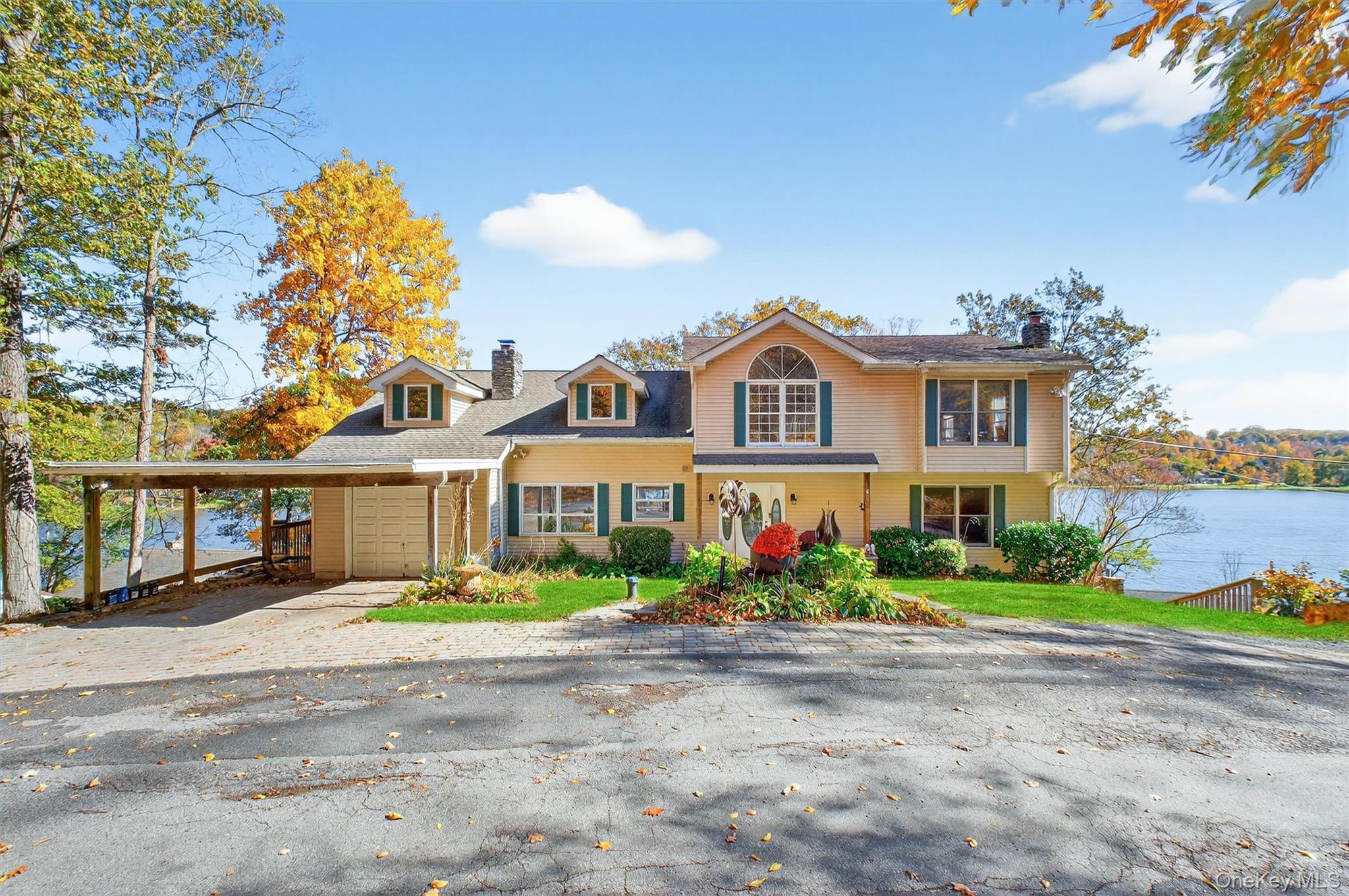10 Byram Road Carmel, NY 10512 - Photo 1 of 49 a front view of a house with a garden and plants