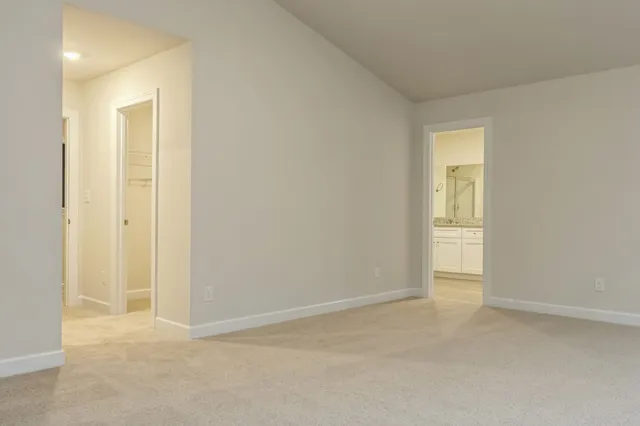 an empty room with closet and mirror