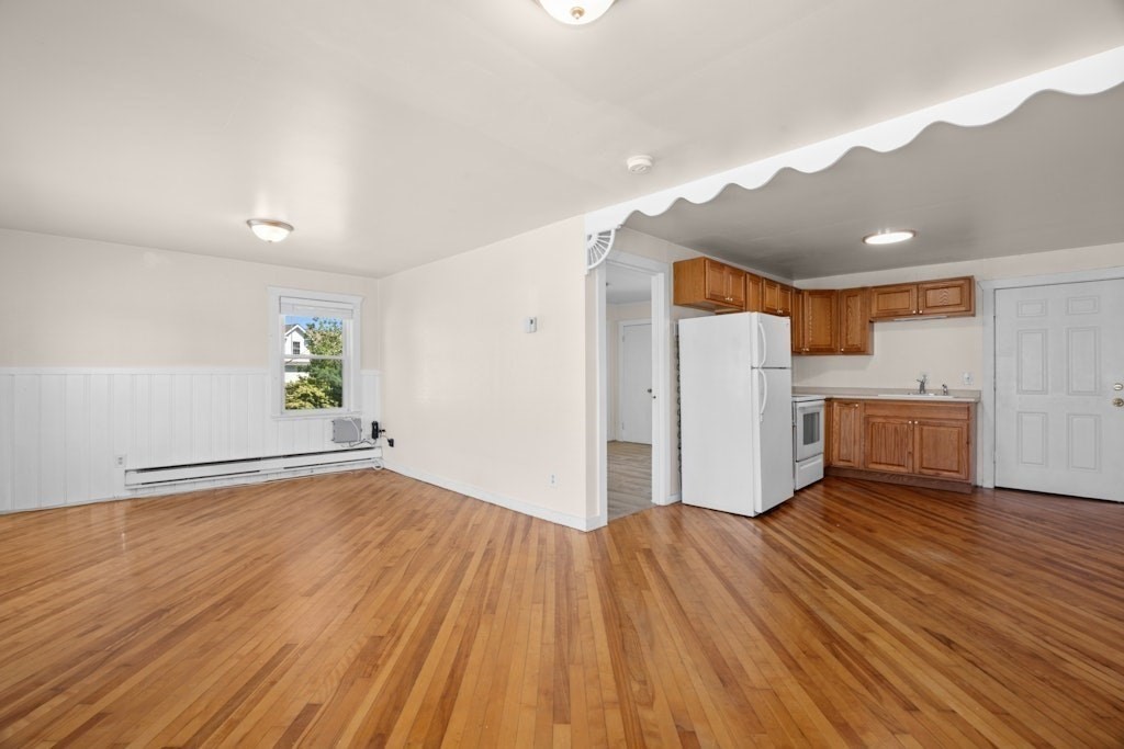 281 C King, Unit C Northborough, MA 01532 - Photo 7 of 19 a view of a kitchen with wooden floor and a refrigerator