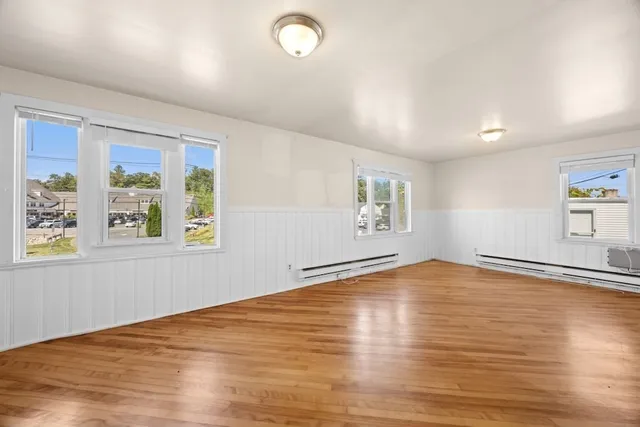 wooden floor in an empty room with a window