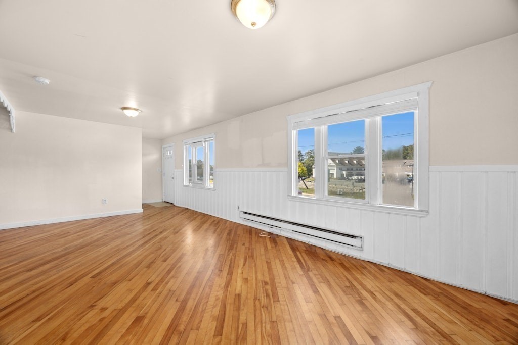 281 C King, Unit C Northborough, MA 01532 - Photo 10 of 19 a view of an empty room with wooden floor and a window
