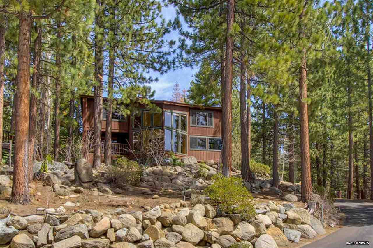 a view of a house with a tree in the yard