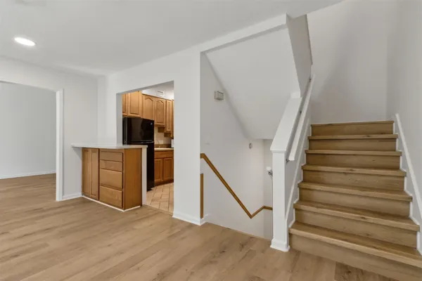 a view of an entryway with wooden floor