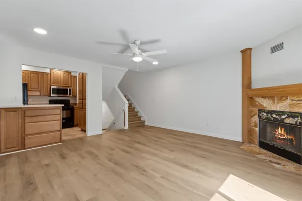 wooden floor in an empty room with a fireplace
