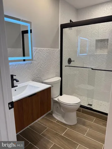 a bathroom with a sink toilet and shower
