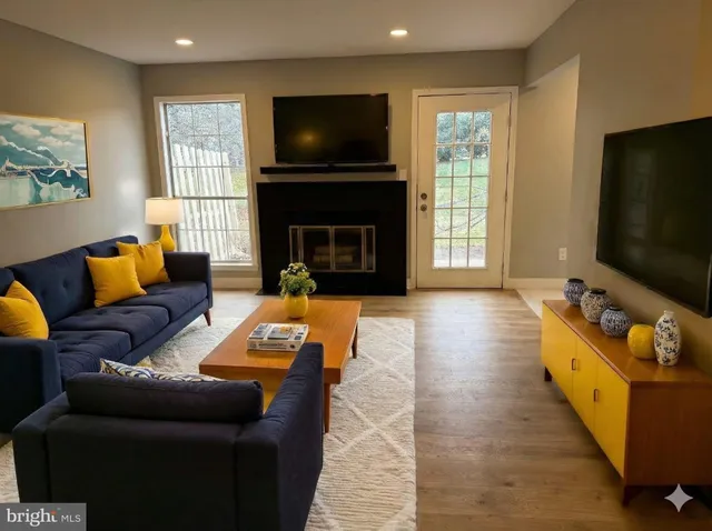 a living room with furniture and a flat screen tv