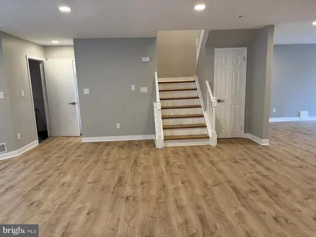 a view of an empty room with stairs and ventilation